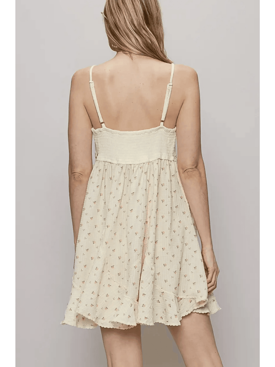 Back view of Trendsi cream summer cami dress with adjustable straps and floral print mini dress