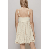 Back view of Trendsi cream summer cami dress with adjustable straps and floral print mini dress
