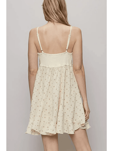 Back view of Trendsi cream summer cami dress with adjustable straps and floral print mini dress