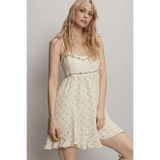 Trendsi cream summer cami dress with floral print and ruffled hem worn by model