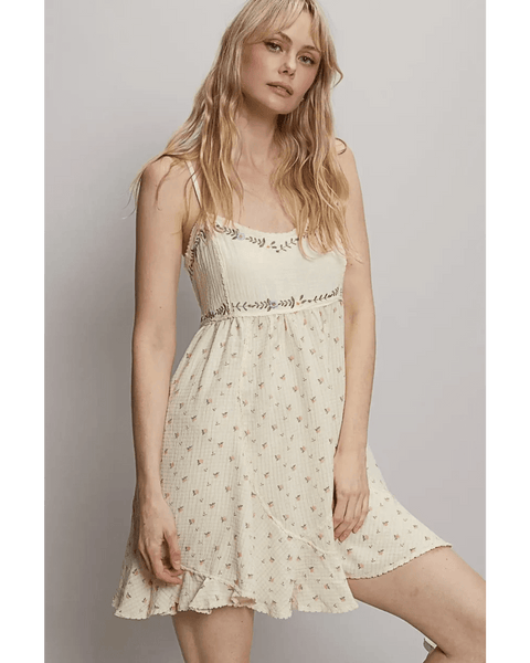 Trendsi cream summer cami dress with floral print and ruffled hem worn by model