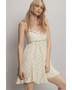 Trendsi cream summer cami dress with floral print and ruffled hem worn by model