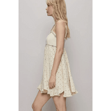 Trendsi cream summer cami dress with floral pattern and ruffled hem worn by a model