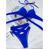 Blue Beach Babes crisscross halter neck bikini laid flat on magazine background