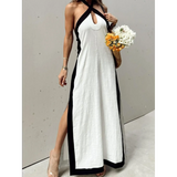 Trendsi crisscross maxi dress for women in white with black trim and halter neckline holding bouquet