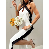 Trendsi crisscross maxi dress for women in white with black accents worn with sandals and holding flowers
