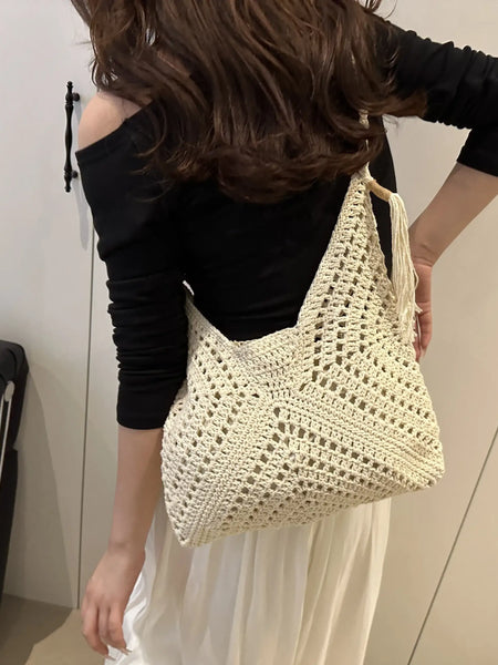 Babe Beachwaer Crochet Summer Shoulder bag in cream worn by woman with black top and white skirt
