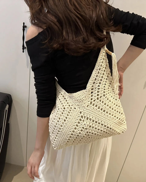 Babe Beachwaer Crochet Summer Shoulder bag in cream worn by woman with black top and white skirt
