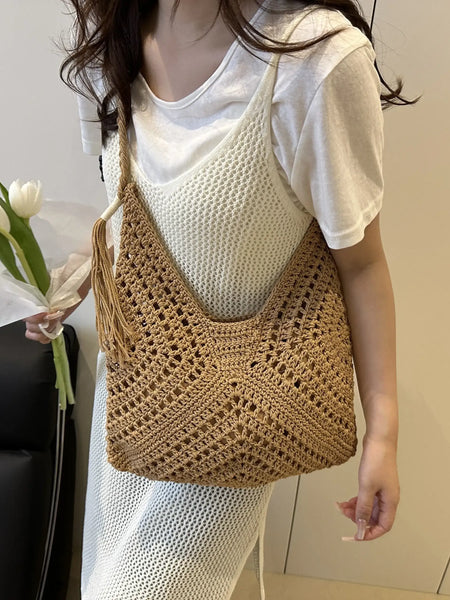 Babe Beachwaer Crochet Summer Shoulder bag in brown worn by woman with white outfit holding flowers
