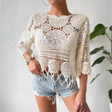 Trendsi cotton crochet fringe top in white with circular patterns and tassels worn with denim shorts