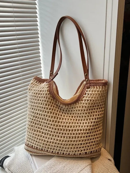 Trendsi crochet tote bag with leather handles in beige and brown hanging near window blinds