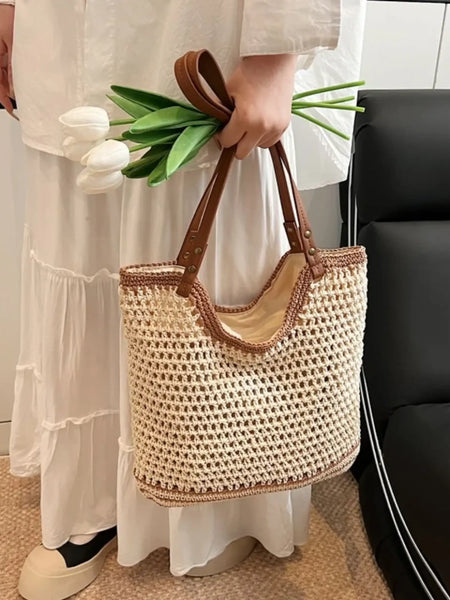 crochet tote bag with leather handles held by person wearing white dress and holding white tulips