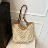 crochet tote bag with leather handles in cream and brown colors on a white surface