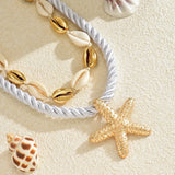 Trendsi cruise wear beaded rope necklace with gold starfish pendant and shell details on sandy background