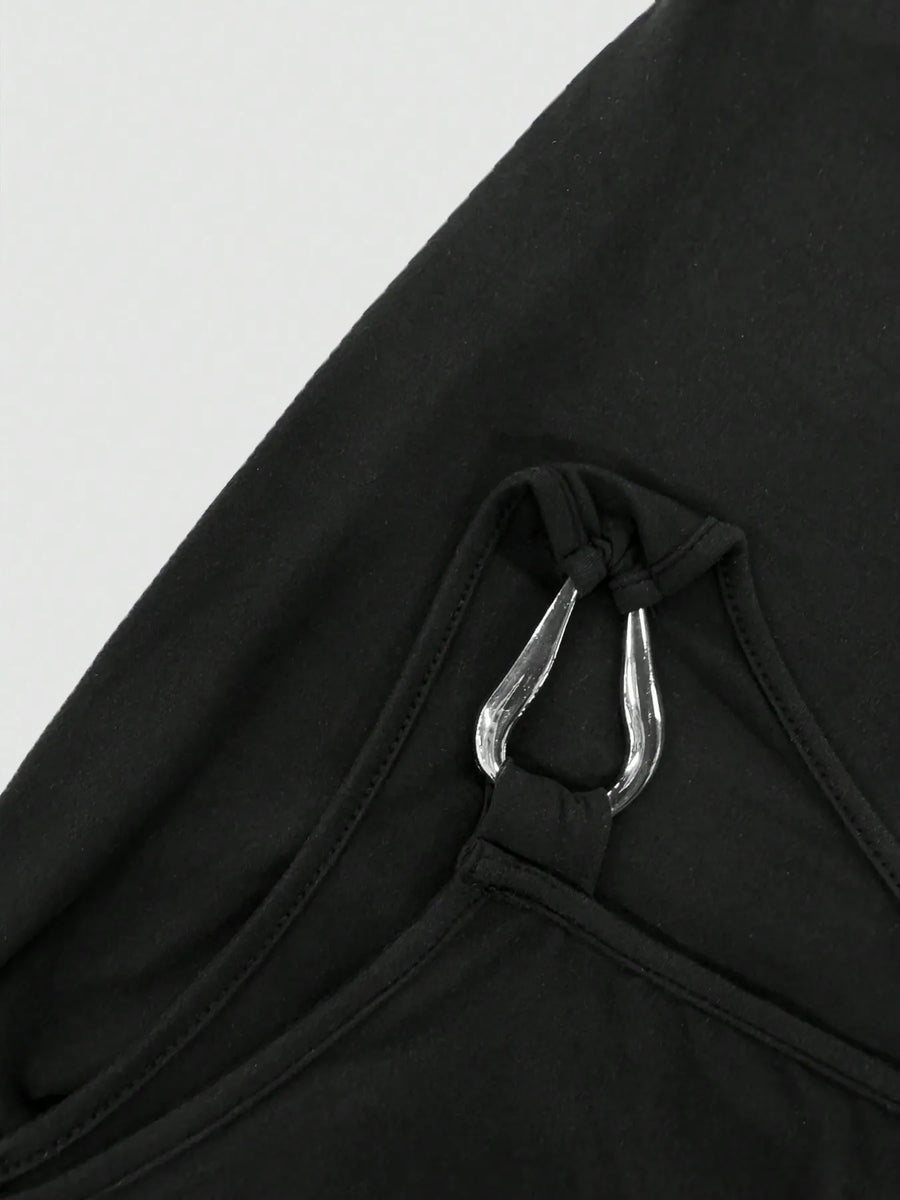 Close-up of black mini dress strap with silver metal ring detail from Trendsi