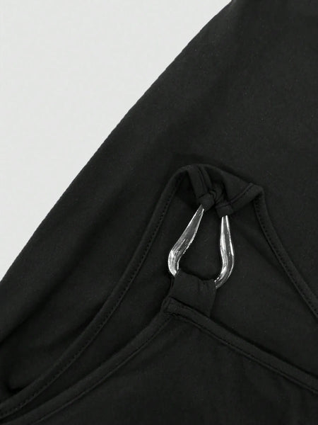 Close-up of black mini dress strap with silver metal ring detail from Trendsi