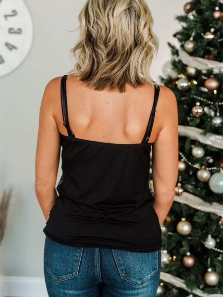 Trendsi black tank top dressy summer cami for beachwear worn by woman with blonde hair in front of decorated Christmas tree