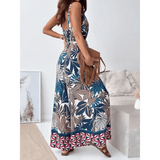 Trendsi Earth Toned Tropical Jumpsuit with sleeveless design and wide-leg pants worn with brown fringe bag
