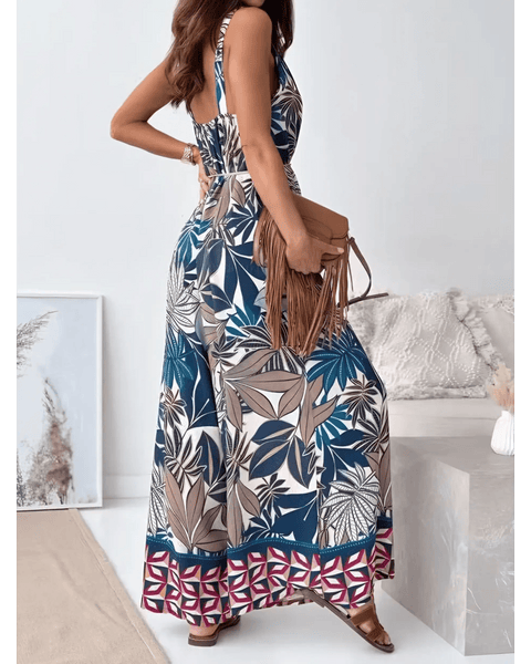 Trendsi Earth Toned Tropical Jumpsuit with sleeveless design and wide-leg pants worn with brown fringe bag