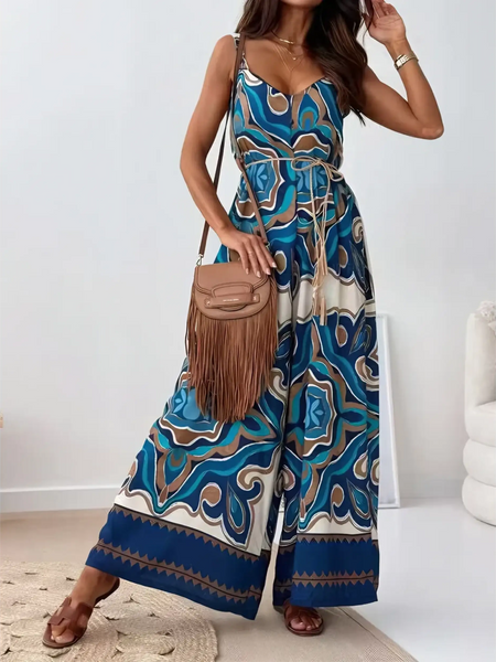 Trendsi Earth Toned Tropical Jumpsuit with wide legs and sleeveless design styled with brown fringe bag