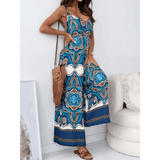 Woman wearing an Earth Toned Tropical Jumpsuit with blue and brown geometric patterns from Trendsi