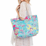 Babe Beachwear colorful easy to pack summer beach bag carried by woman in white lace dress