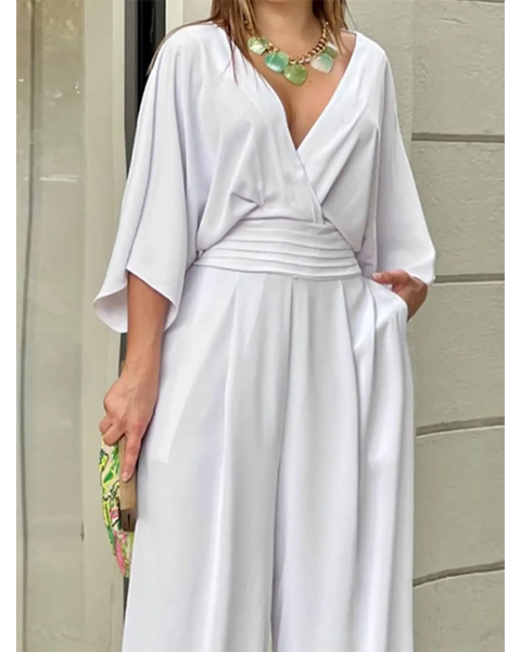 Babe Beachwear elegant wide-leg beachwear jumpsuit in white with deep V-neck and loose sleeves