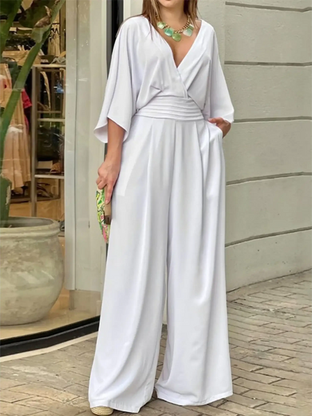 Elegant wide-leg beachwear jumpsuit by Babe Beachwaer in white with a deep V-neck and flowing sleeves