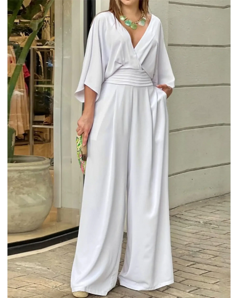 Elegant wide-leg beachwear jumpsuit by Babe Beachwaer in white with a deep V-neck and flowing sleeves