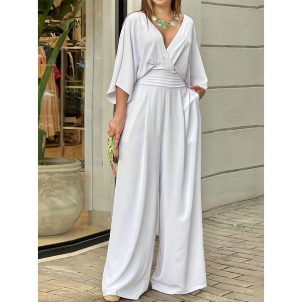 Elegant wide-leg beachwear jumpsuit by Babe Beachwaer in white with a deep V-neck and flowing sleeves