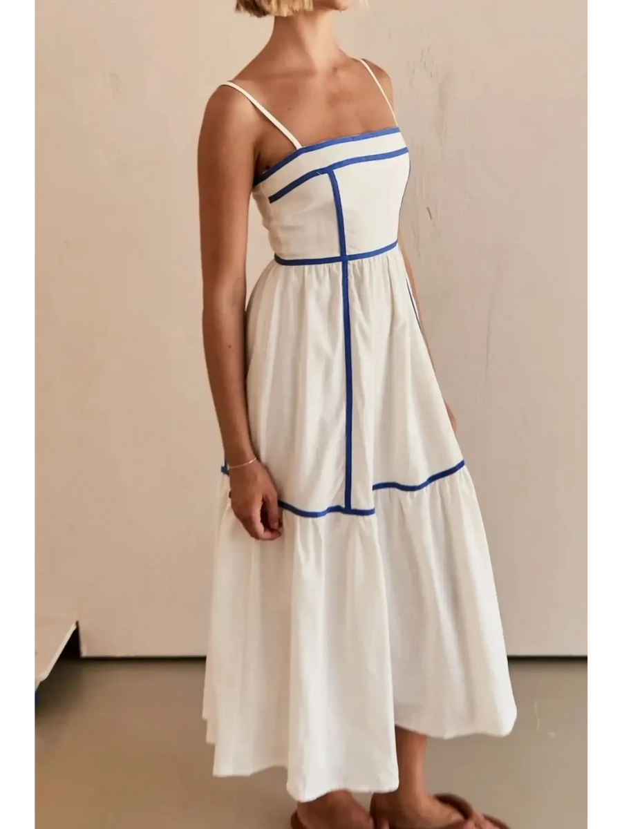 Side view of white contrast trim midi dress with blue piping and spaghetti straps