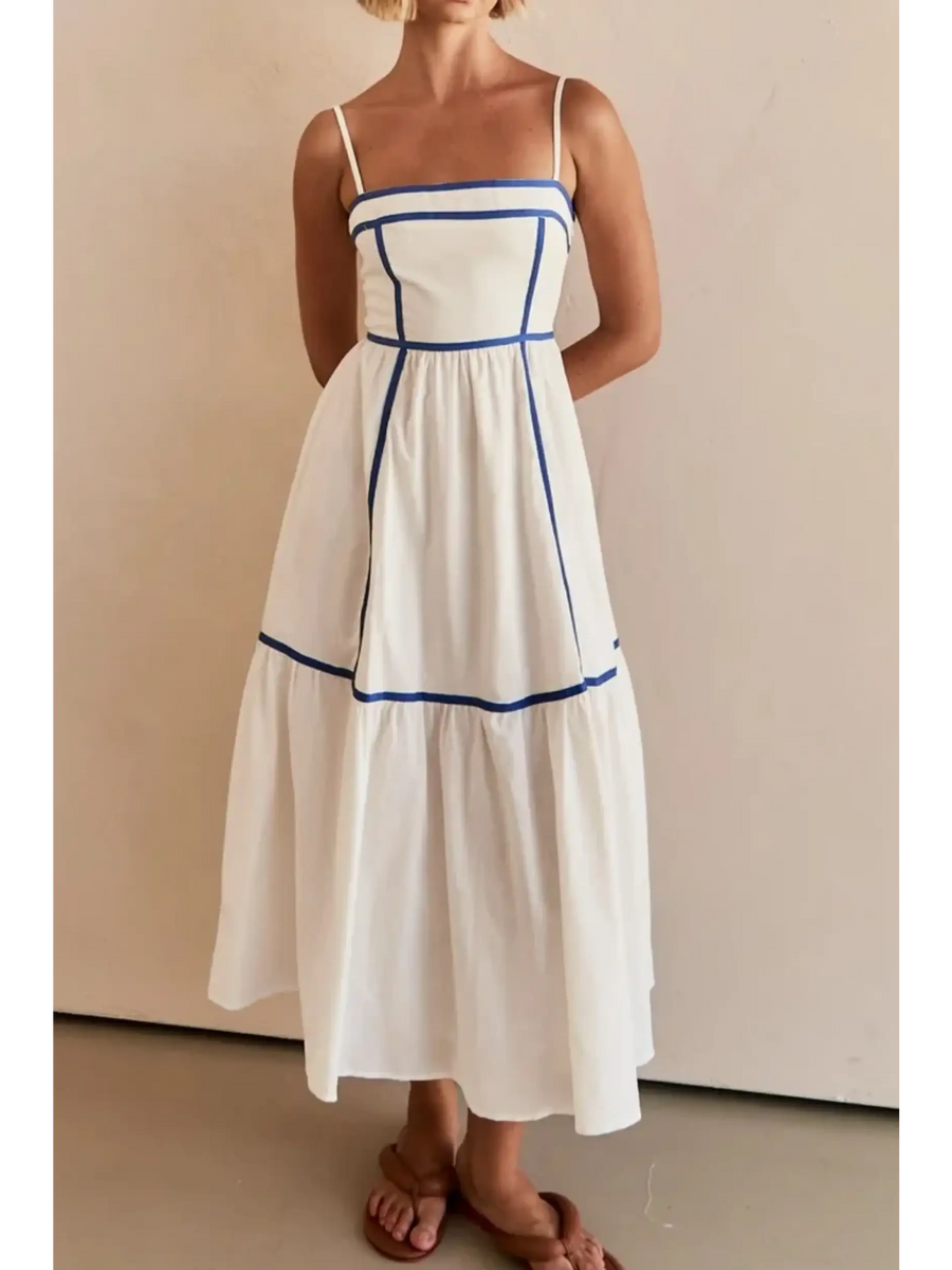 woman wearing white contrast trim midi dress with blue piping and spaghetti straps