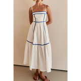 woman wearing white contrast trim midi dress with blue piping and spaghetti straps