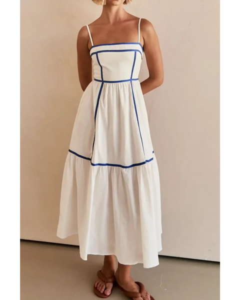 woman wearing white contrast trim midi dress with blue piping and spaghetti straps