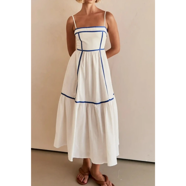 woman wearing white contrast trim midi dress with blue piping and spaghetti straps