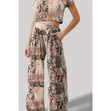 Trendsi floral patterned pants set with a crop top featuring a relaxed fit and pockets