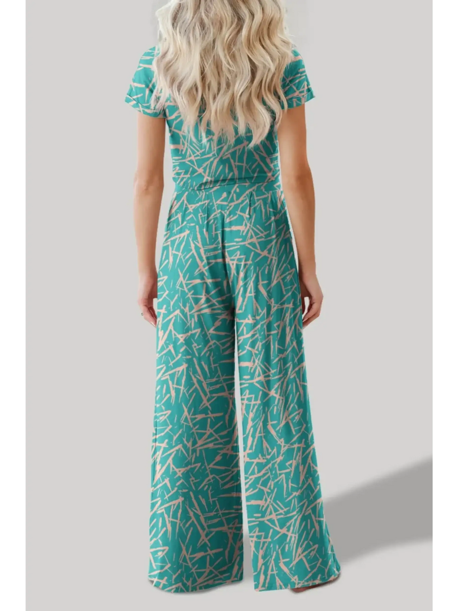 Back view of woman wearing turquoise crop top pants set with abstract print from Trendsi