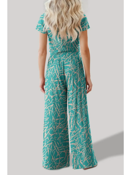 Back view of woman wearing turquoise crop top pants set with abstract print from Trendsi