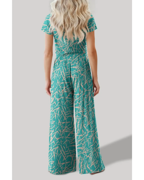 Back view of woman wearing turquoise crop top pants set with abstract print from Trendsi
