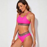 Trendsi fierce pink bikini for beach with leopard print trim on top and bottom worn by smiling woman