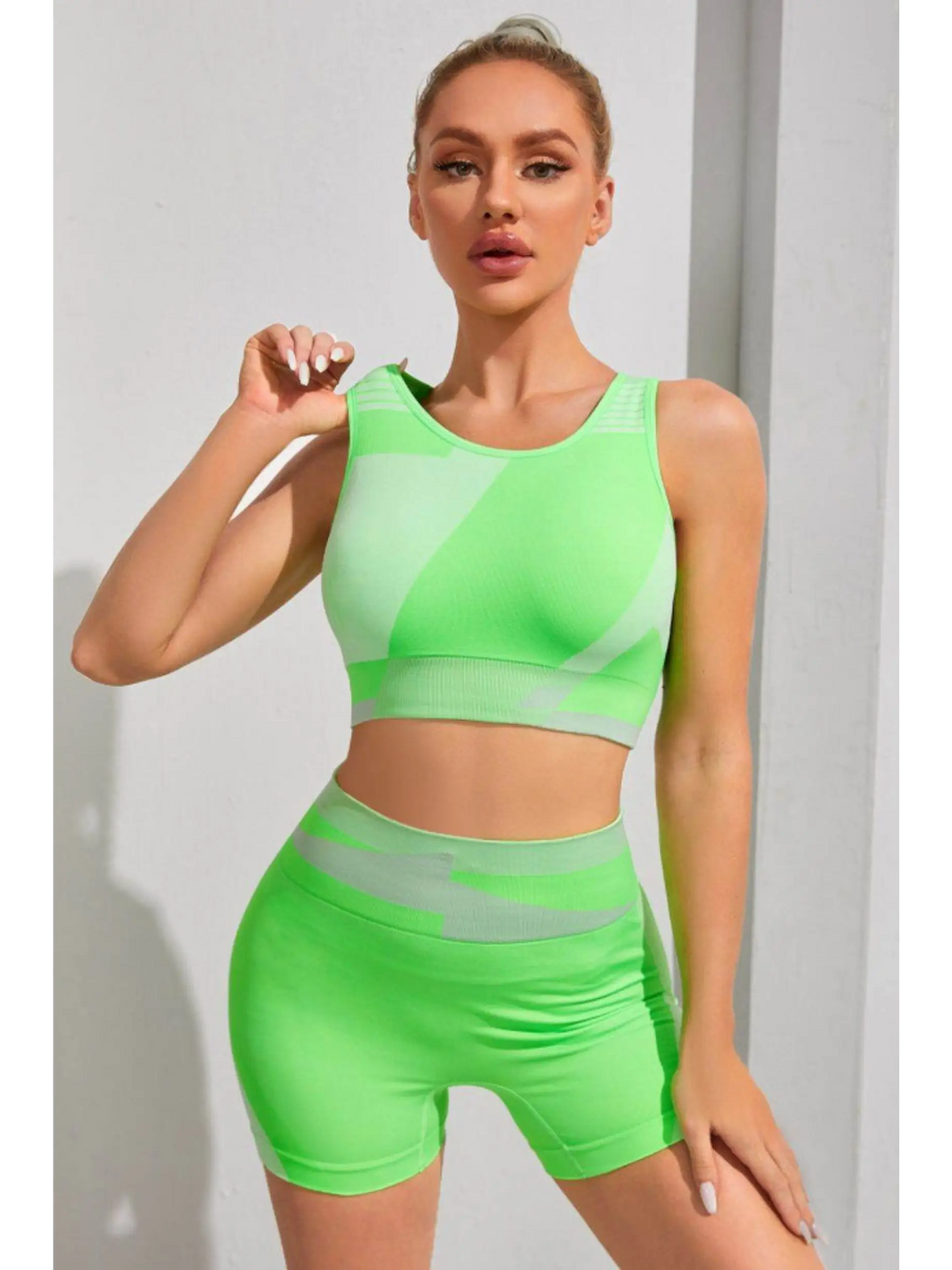 Babe Beachwear neon green color block sports bra and shorts set on woman posing indoors