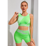 Babe Beachwear neon green color block sports bra and shorts set on woman posing indoors