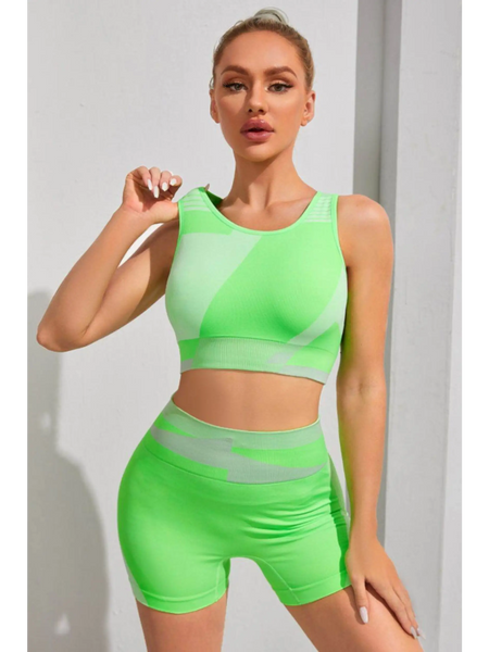 Babe Beachwear neon green color block sports bra and shorts set on woman posing indoors