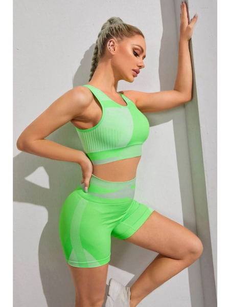 Babe Beachwear color block sports bra and shorts set in vibrant green worn by model