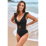 Babe Beachwear flattering one piece swimwear in black with ruffle details and belt at the beach