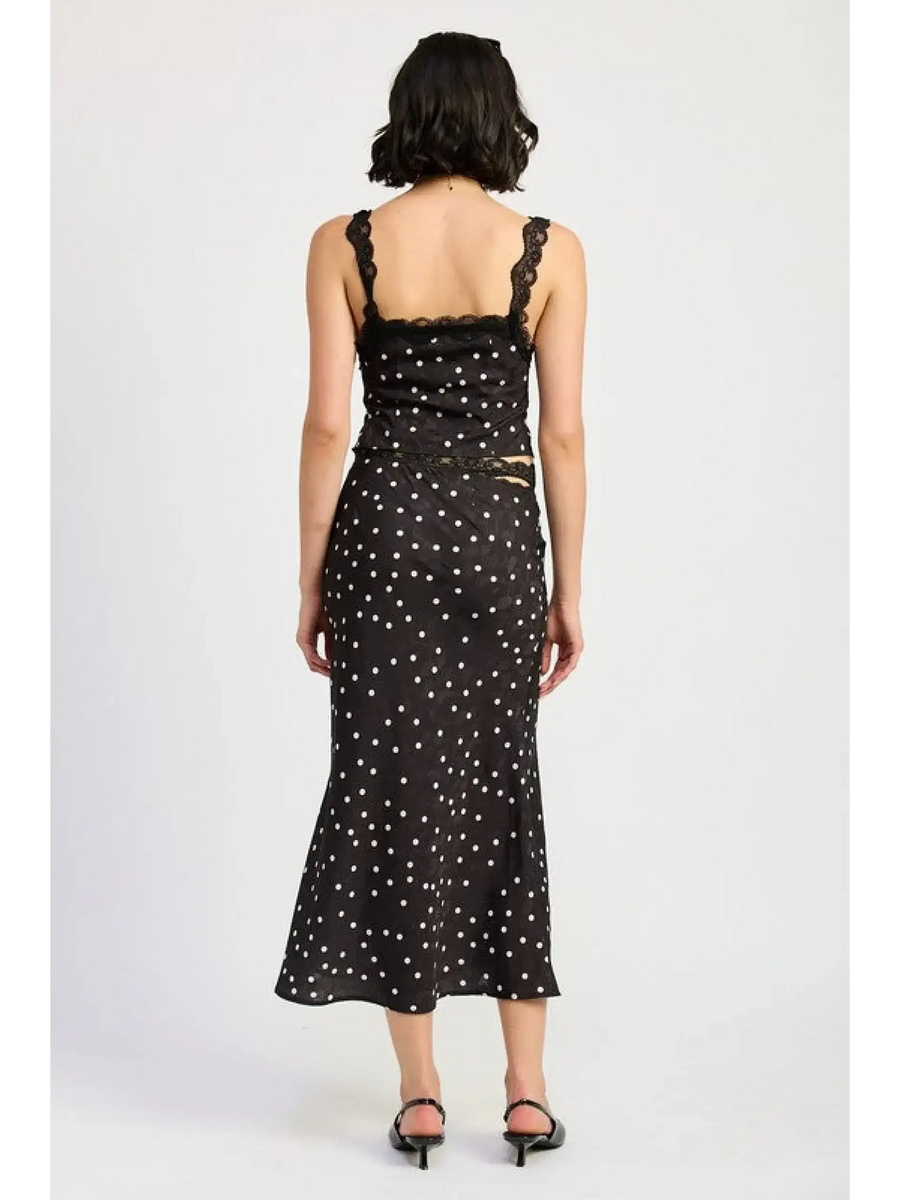 Back view of flattering polka dot cami for women paired with matching midi skirt and black heels
