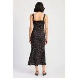 Back view of flattering polka dot cami for women paired with matching midi skirt and black heels