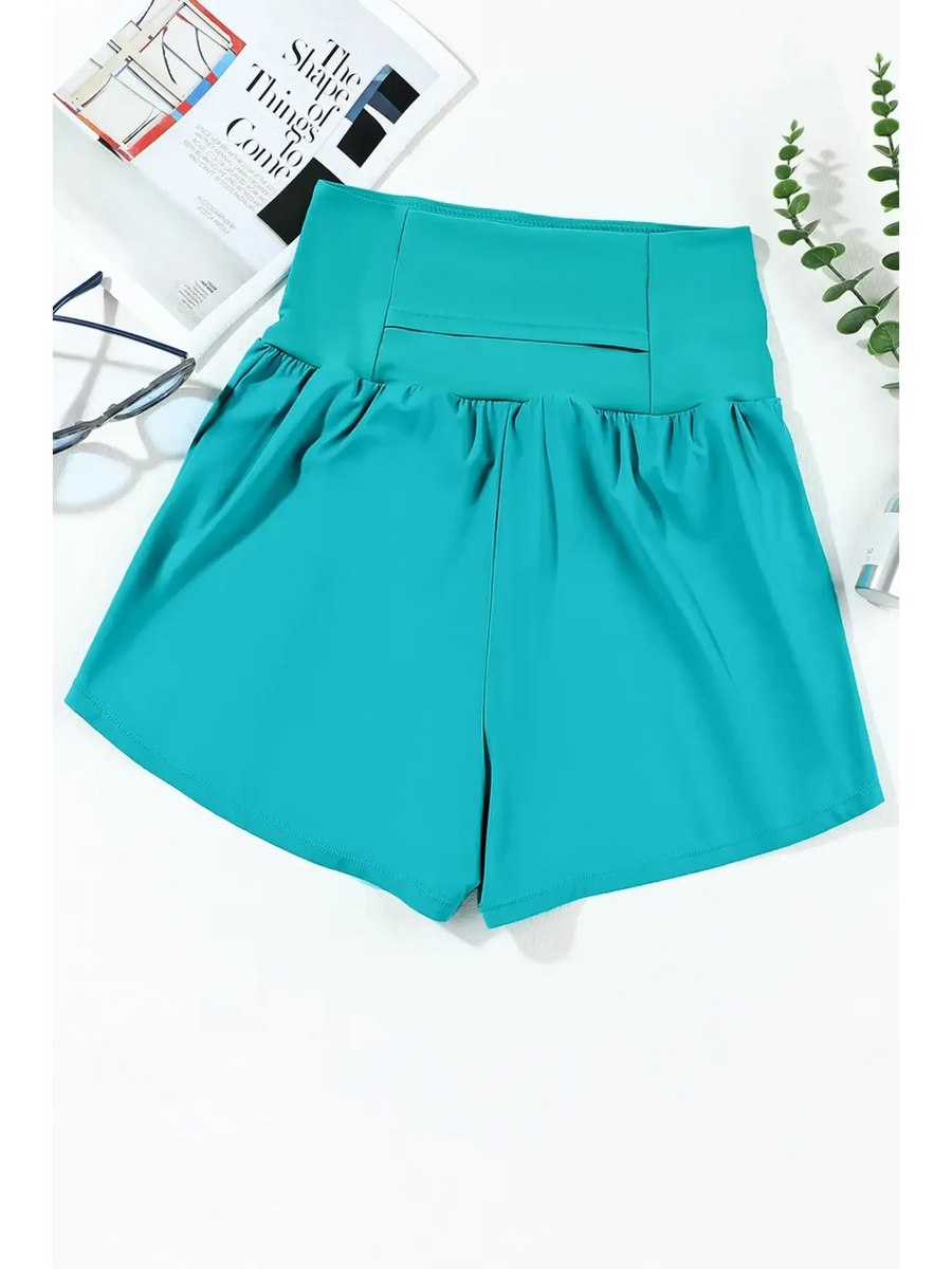 Beach Babes teal swim shorts featuring flattering swimsuit bottoms with pockets for stylish beachwear