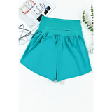 Beach Babes teal swim shorts featuring flattering swimsuit bottoms with pockets for stylish beachwear