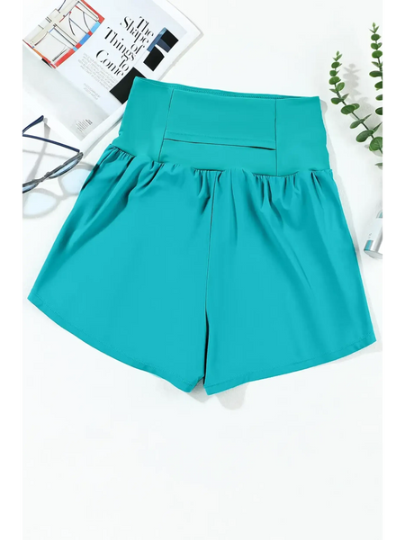 Beach Babes teal swim shorts featuring flattering swimsuit bottoms with pockets for stylish beachwear